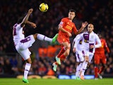 Philippe Coutinho of Liverpool challenges for the ball with Leandro Bacuna of Aston Villa during the Barclays Premier League match 