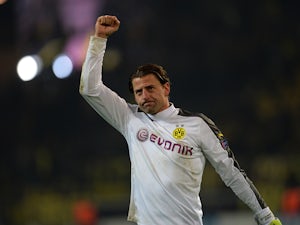 Dortmund's Roman Weidenfeller celebrates his team's win against Napoli during their Champions League match on November 26, 2013