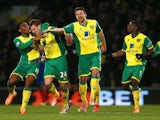 Leroy Fer and Russell Martin of Norwich City congratulate Ryan Bennett of Norwich City on scoring their first goal during the Barclays Premier League match against Hull City on January 18, 2014