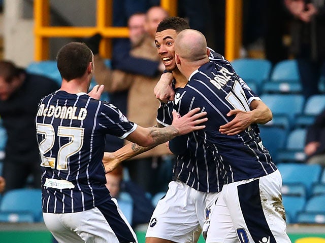 Millwall's Ryan Fredericks celebrates with teammates after scoring the opening goal against Ipswich during their Championship match on January 18, 2014