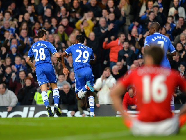 Chelsea's Samuel Eto'o celebrates with teammate Cesar Azpilicueta after scoring his team's opening goal against Man United during their Premier League match on January 19, 2014