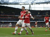 Arsenal's Spanish midfielder Santi Cazorla celebrates scoring the opening goal with teammate Olivier Giroud during the English Premier League football match against Fulham on January 18, 2014
