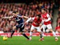 Sascha Riether of Fulham evades Santi Cazorla and Nacho Monreal of Arsenal during the Barclays Premier League match on January 18, 2014