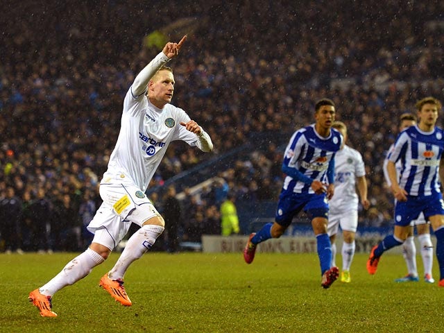Macclesfield Town's Scott Boden celebrates after scoring his team's first goal via the penalty spot against Sheffield Wednesday during their FA Cup third round replay match on January 14, 2014