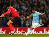 Sergio Aguero of Manchester City shoots past Steven Caulker of Cardiff to score his team's fourth goal during the Barclays Premier League match on January 18, 2014