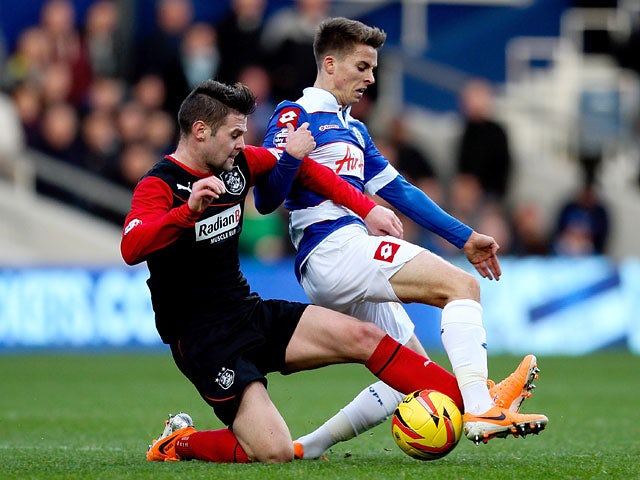 QPR's Tom Carroll and Huddersfield's Oliver Norwood in action during their Championship match on January 18, 2014