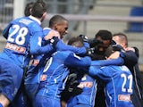 Troyes' players celebrate after winning the French League Cup quarter final football match Troyes vs Evian, on January 15, 2014