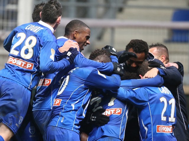 Troyes' players celebrate after winning the French League Cup quarter final football match Troyes vs Evian, on January 15, 2014
