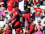 Bruce Djite of Adelaide United celebrates after scoring a goal with his team mate Awer Mabil of Adelaide United during the round 16 A-League match between Adelaide United and the Melbourne Heart at Coopers Stadium on January 25, 2014