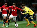 Adnan Januzaj of Manchester United is challenged by Marcos Alonso of Sunderland during the Capital One Cup semi final, second leg match on January 22, 2014