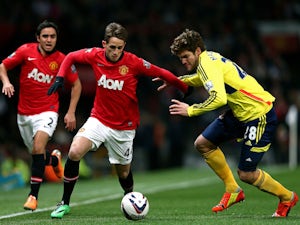 Adnan Januzaj of Manchester United is challenged by Marcos Alonso of Sunderland during the Capital One Cup semi final, second leg match on January 22, 2014