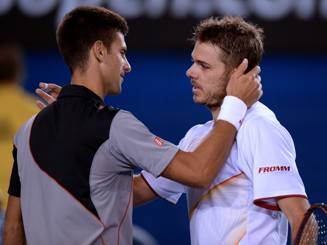 Switzerland's Stanislas Wawrinka shakes hands as he celebrates after victory in his men's singles match against Serbia's Novak Djokovic on day nine at the 2014 Australian Open tennis tournament in Melbourne on January 21, 2014