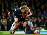 Ben Coker of Southend is challenged by George Boyd of Hull City during the FA Cup fourth round match between Southend United and Hull City at Roots Hall on January 25, 2014