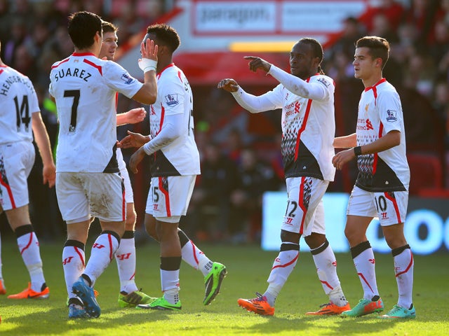 Victor Moses of Liverpool points at Luis Suarez of Liverpool as he celebrates scoring the opening goal with his team mates during the FA Cup Fourth Round match between Bournemouth and Liverpool at Goldsands Stadium on January 25, 2014