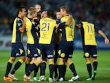 Anthony Caceres of the Mariners celebrates with team mates after scoring the opening goal during the round 16 A-League match between the Central Coast Mariners and the Newcastle Jets at Bluetongue Stadium on January 25, 2014