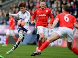 Bolton Wanderers' South Korean midfielder Chung-Yong Lee (L) has a shot at goal during the English FA Cup fourth round football match between Bolton Wanderers and Cardiff City on January 25, 2014