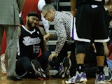 DeMarcus Cousins #15 of the Sacramento Kings sits on the court after a hard foul during the game against the Houston Rockets at the Toyota Center on January 22, 2014