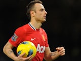 Dimitar Berbatov leaves with the match ball after scoring five goals against Blackburn Rovers on November 26, 2011.