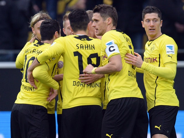 Dortmund´s players celebrate during the German first division Bundesliga football match Borussia Dortmund vs FC Augsburg in the German city of Dortmund on January 25, 2014