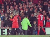 Eric Cantona is guided away after assaulting a Crystal Palace fan on January 25, 1995.