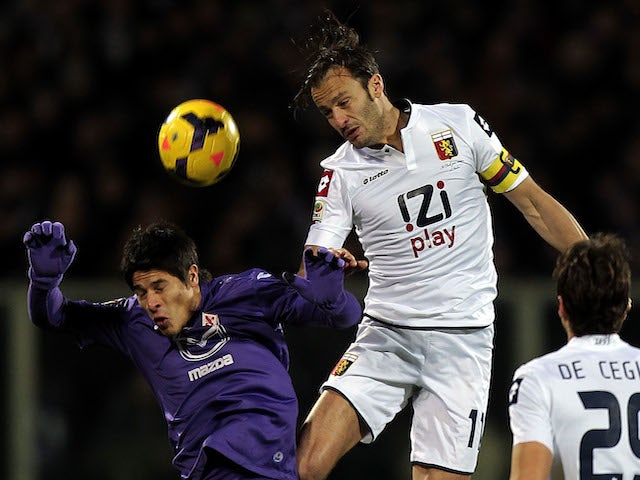 Facundo Ronacaglia of ACF Fiorentina fights for the ball with Alberto Gilardino of Genoa CFC during the Serie A match on January 26, 2014