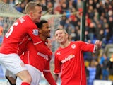 Cardiff City's English forward Fraizer Campbell (C) celebrates after scoring the opening goal with teammates English midfielder Craig Noone (L) and Scottish defender Kevin McNaughton against Bolton on January 25, 2014