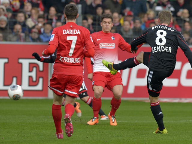 Leverkusen's midfielder Lars Bender scores the opening goal during the German first division Bundesliga football match SC Freiburg vs Bayer 04 Leverkusen in Freiburg, southwestern Germany, on January 25, 2014