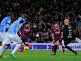 Gerard Pique of FC Barcelona scores the opening goal during the La Liga match between FC Barcelona and Malaga CF at Camp Nou on January 26, 2014