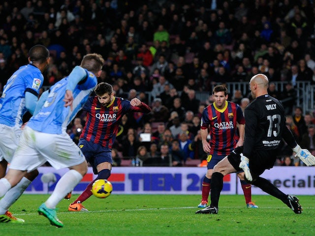 Gerard Pique of FC Barcelona scores the opening goal during the La Liga match between FC Barcelona and Malaga CF at Camp Nou on January 26, 2014