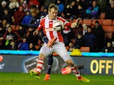 Manchester United's French defender Patrice Evra beats Stoke City's Irish midfielder Glenn Whelan to score the second goal during the English League Cup Quarter-Final football match between Stoke City And Manchester United at Britannia Stadium in Stoke on