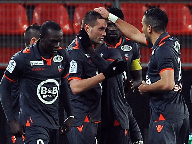 Lorient's French defender Gregory Bourillon (C) is congratulated by teammates after scoring a goal during the French L1 football match against Valenciennes on January 25, 2014