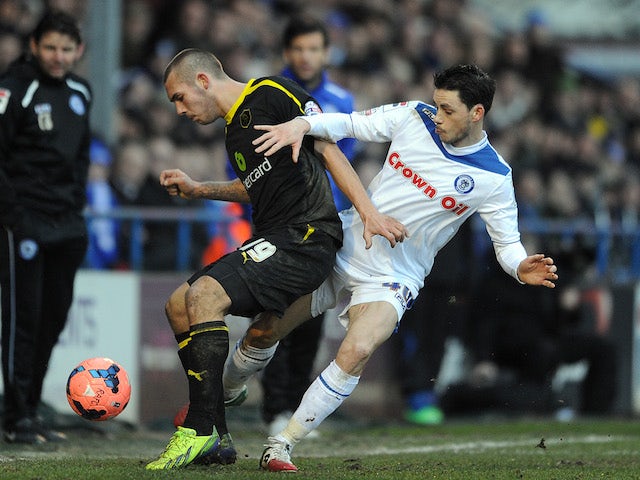 Ian Henderson of Rochdale in action with Joe Mattock of Sheffield Wednesday during the FA Cup with Budweiser Fourth Round match on January 25, 2014