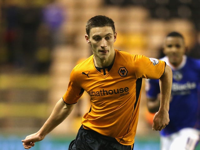 Jake Cassidy of Wolves runs with the ball during the FA Cup First Round Replay match between Wolverhampton Wanderers and Oldham Athletic at Molineux on November 19, 2013