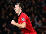 Jonny Evans of Manchester United celebrates after scoring the opening goal as a dejected John O'Shea of Sunderland looks on during the Capital One Cup semi final on January 22, 2014