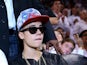Singer Justin Bieber sits courtside as he watches the Miami Heat host the Indiana Pacers during Game Seven of the Eastern Conference Finals of the 2013 NBA Playoffs at AmericanAirlines Arena on June 3, 2013