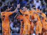 Real Madrid's French forward Karim Benzema is congratulated by his teammates after scoring the opener during the Spanish Copa del Rey quarter-final first-leg football match against Espanyol on January 21, 2014