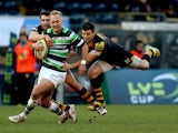 Shane Geraghty of London Irish is tackled by Tommy Bell of Wasps during the LV=Cup match between London Wasps and London Irish at Adams Park on January 25, 2014