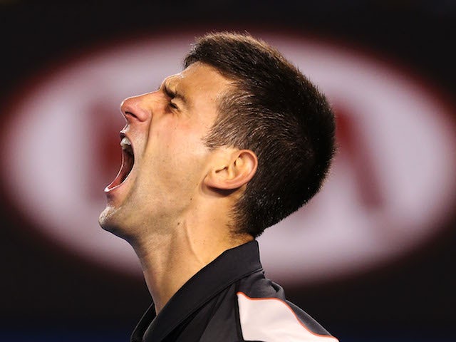 Novak Djokovic celebrates winning the third set in his quarter-final match against Stanislas Wawrinka at the Australian Open in Melbourne on January 21, 2014