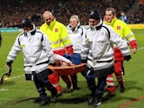 Monaco's Columbian forward Radamel Falcao (C) is lifted away from the pitch after being injured during the French Cup football match between Chasselay (MDA) and Monaco (ASM) on January 22, 2014