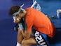 Rafael Nadal puts his head in his hands during the Australian Open final in Melbourne on January 26, 2014