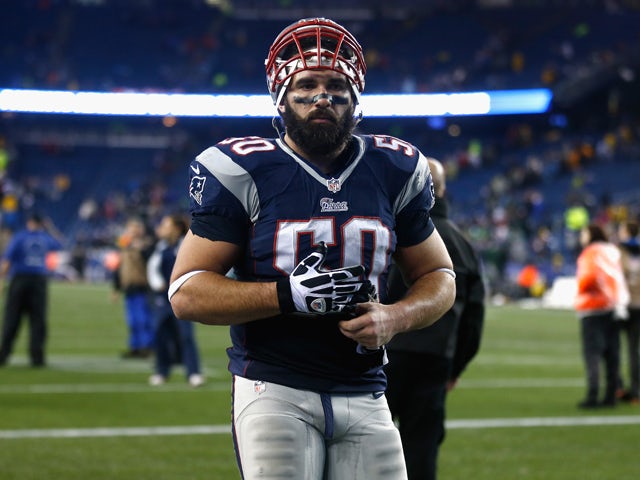 Rob Ninkovich #50 of the New England Patriots runs off the field after defeating the Indianapolis Colts in their AFC Divisional Playoff game at Gillette Stadium on January 11, 2014