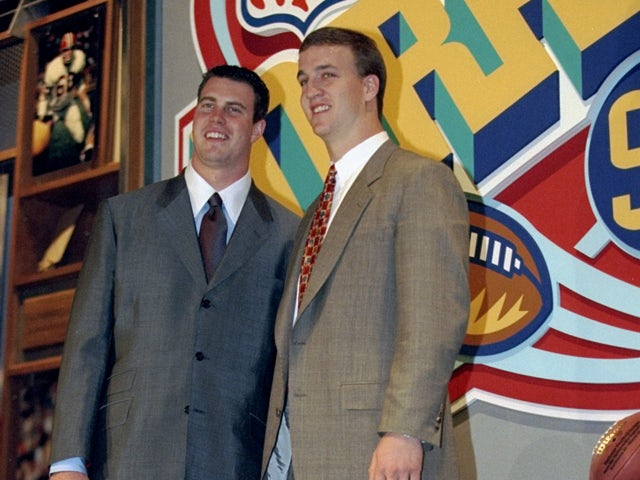 Second overall pick Ryan Leaf poses alongside first overall pick Peyton Manning during the first round of the 1998