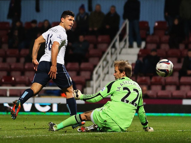 Sergio Aguero of Manchester City beats Jussi Jaaskelainen of West Ham United to score their second goal during the Capital One Cup Semi-Final, Second Leg match on January 21, 2014