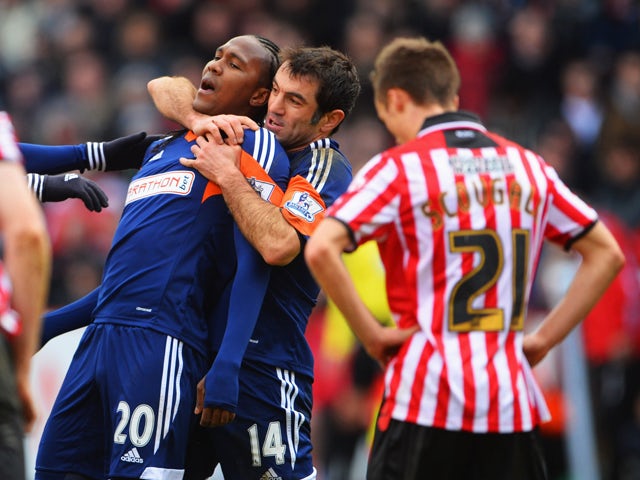 Hugo Rodallega of Fulham celebrates with Giorgos Karagounis as he scores their first goal during the FA Cup with Budweiser fourth round match between Sheffield United and Fulham at Bramall Lane on January 26, 2014