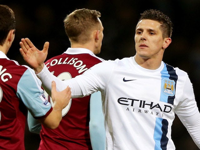 Steven Jovetic of Manchester City (R) dhakes hands with Stewart Downing of West Ham United (L) after the Capital One Cup Semi-Final, Second Leg match on January 21, 2014