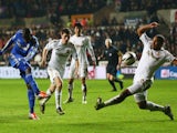 Demba Ba of Chelsea shoots past Ashley Williams of Swansea City during the Capital One Cup Semi-Final Second Leg match between Swansea City and Chelsea at Liberty Stadium on January 23, 2013