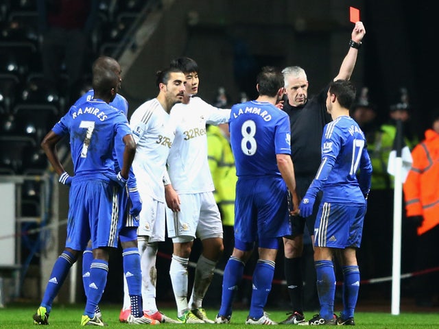 Eden Hazard of Chelsea is sent off by referee Chris Foy after kicking a ball boy during the Capital One Cup Semi-Final Second Leg match between Swansea City and Chelsea at Liberty Stadium on January 23, 2013