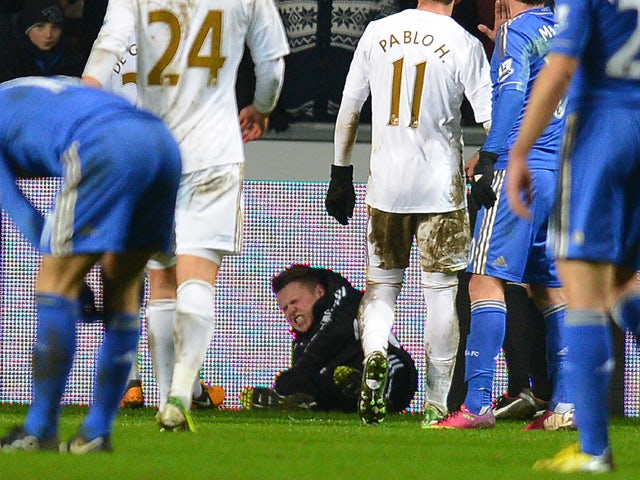 A ballboy lies on the grounf and reacts after a altercation with Chelsea's Belgium midfielder Eden Hazard during the English League Cup semi-final second leg football match between Swansea City and Chelsea at The Liberty stadium in Cardiff, south Wales on