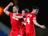 Yann Kermorgant of Charlton celebrates scoring their third goal with team mates during the FA Cup Third Round Replay match against Oxford United on January 21, 2014