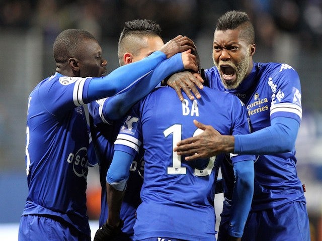 Bastia's Mauritanian midfielder Adama Ba is congratulated by teammates after scoring a goal during the French L1 football match against Guingamp on February 1, 2014